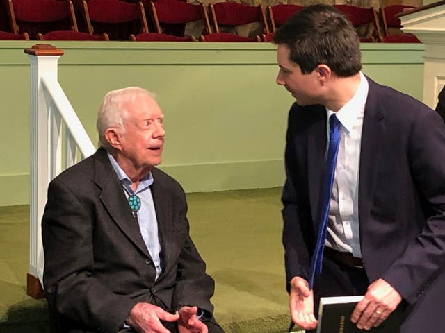 Democratic presidential candidate Pete Buttigieg speaks with former president Jimmy Carter