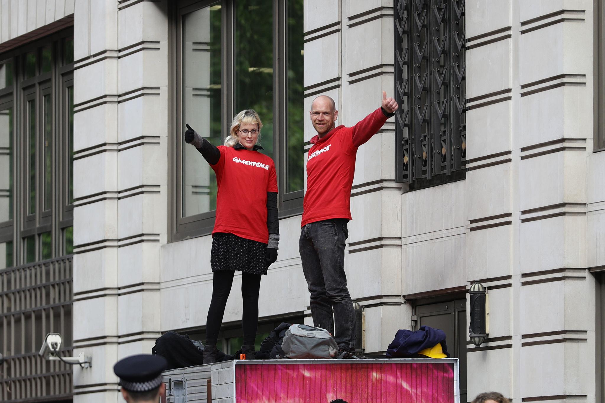 Two activists are inside each container with enough supplies to last at least a week, Greenpeace said