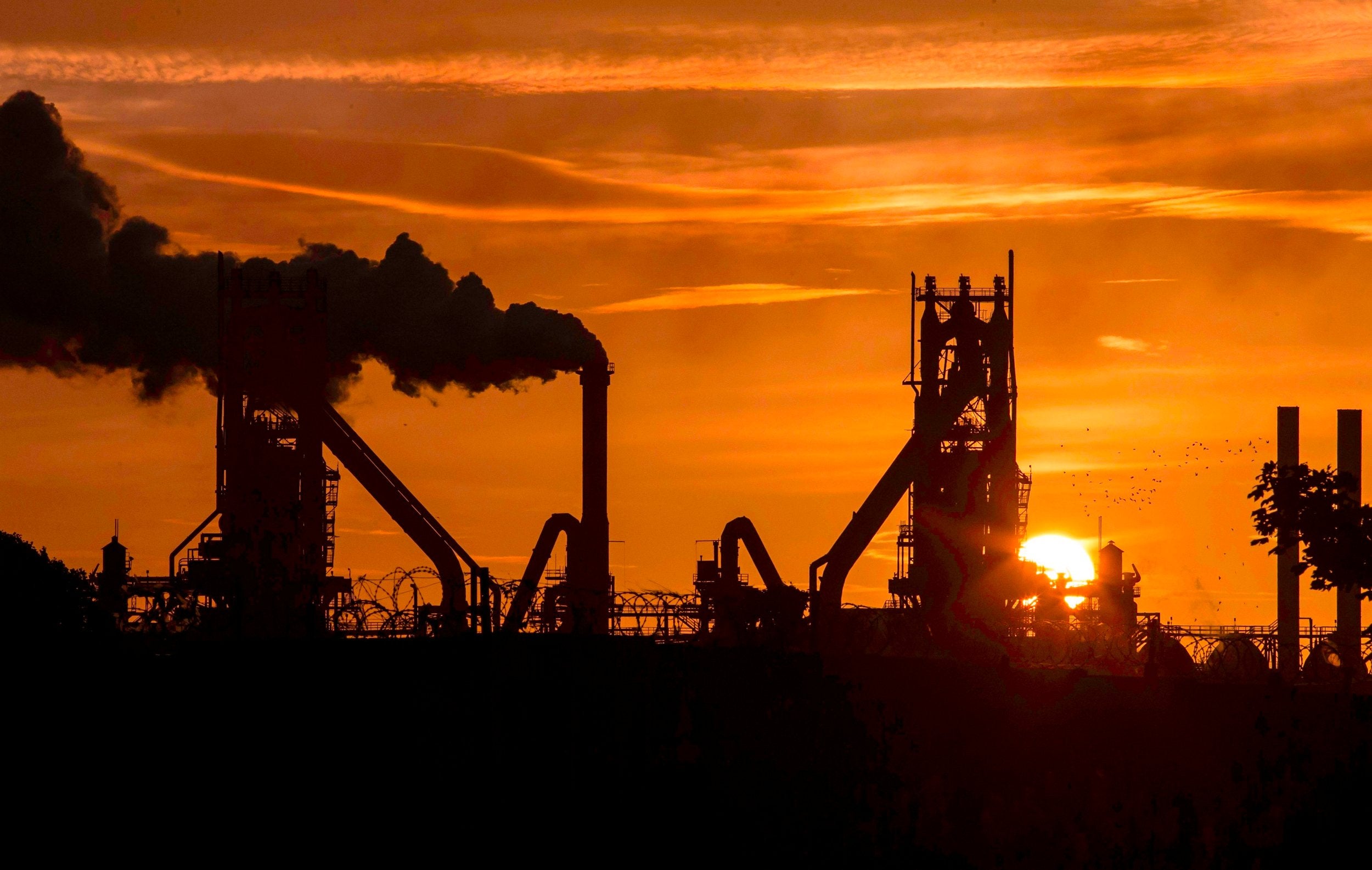 The sun rises behind the British Steel - Scunthorpe plant in north Lincolnshire, north east England