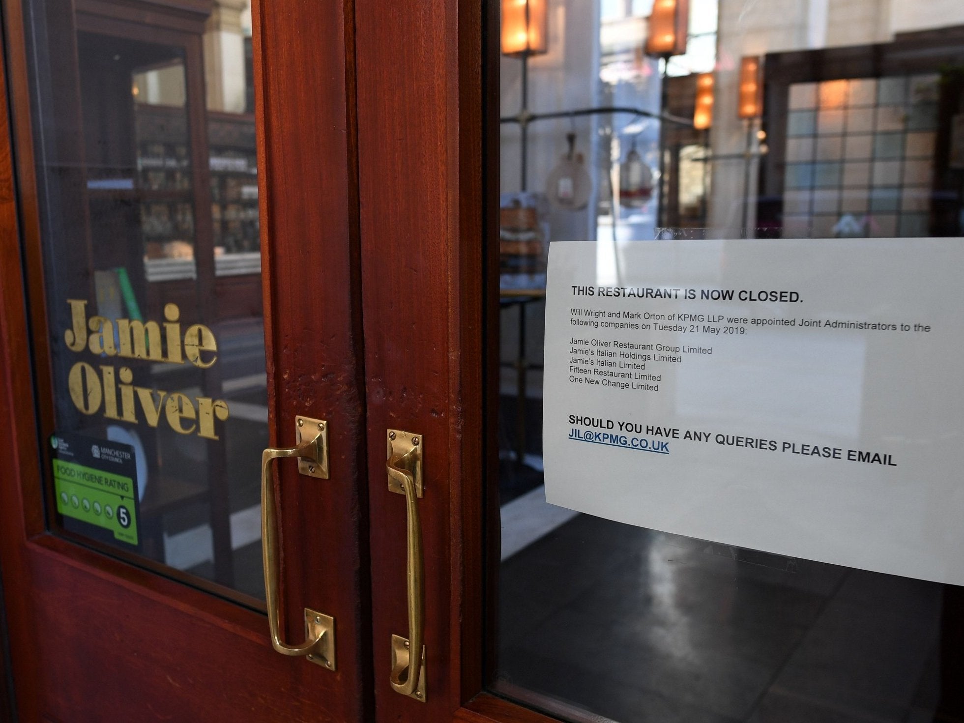 A sign in the door of a closed-down Jamie’s Italian restaurant in Manchester notifies people the KPMG have been appointed as administrators. (AFP/Getty Images)