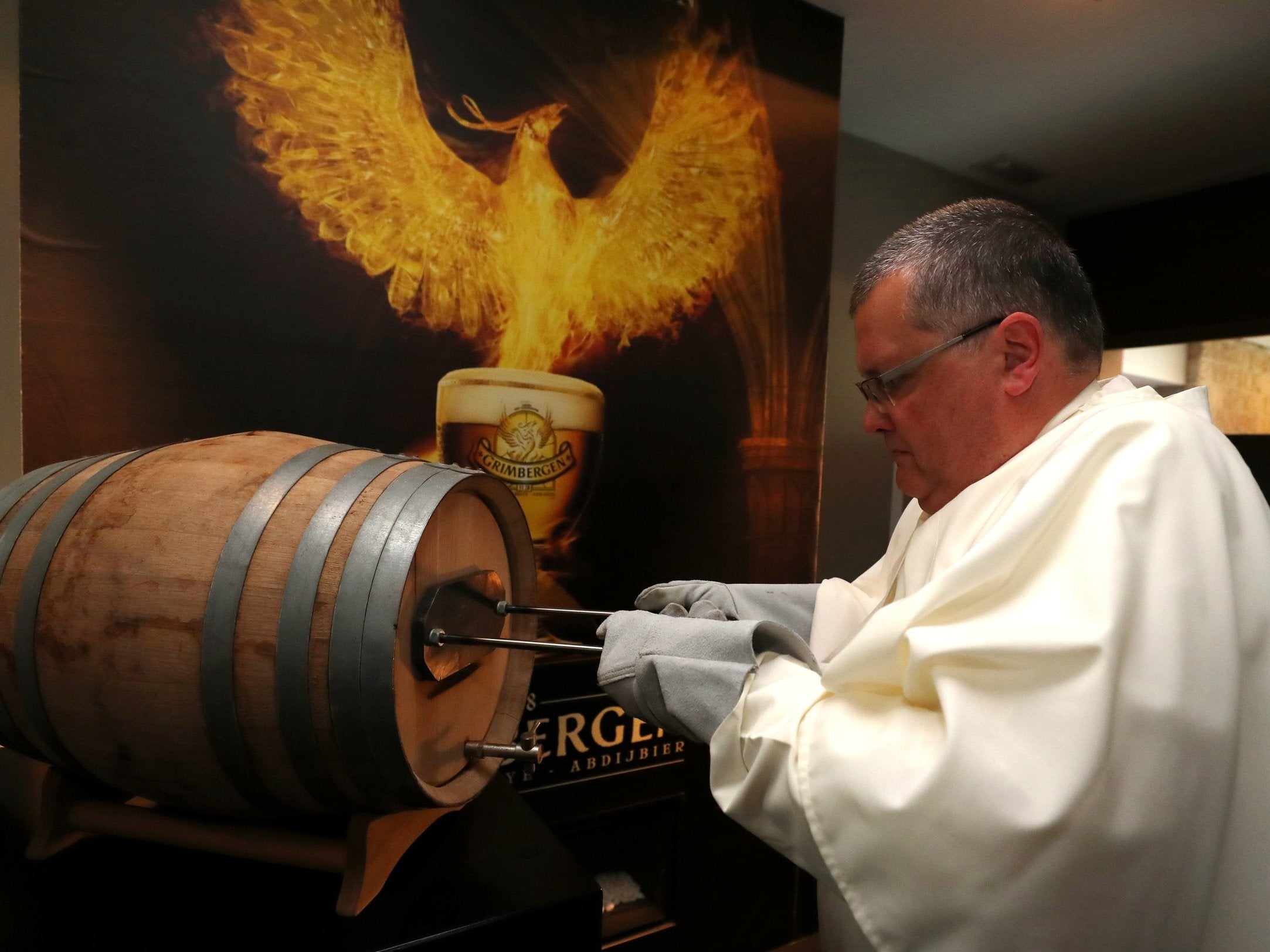 &#13; Norbertine Father Karel marks a barrel of Grimbergen beer, symbolised by a phoenix, at Grimbergen Abbey in Belgium. &#13;