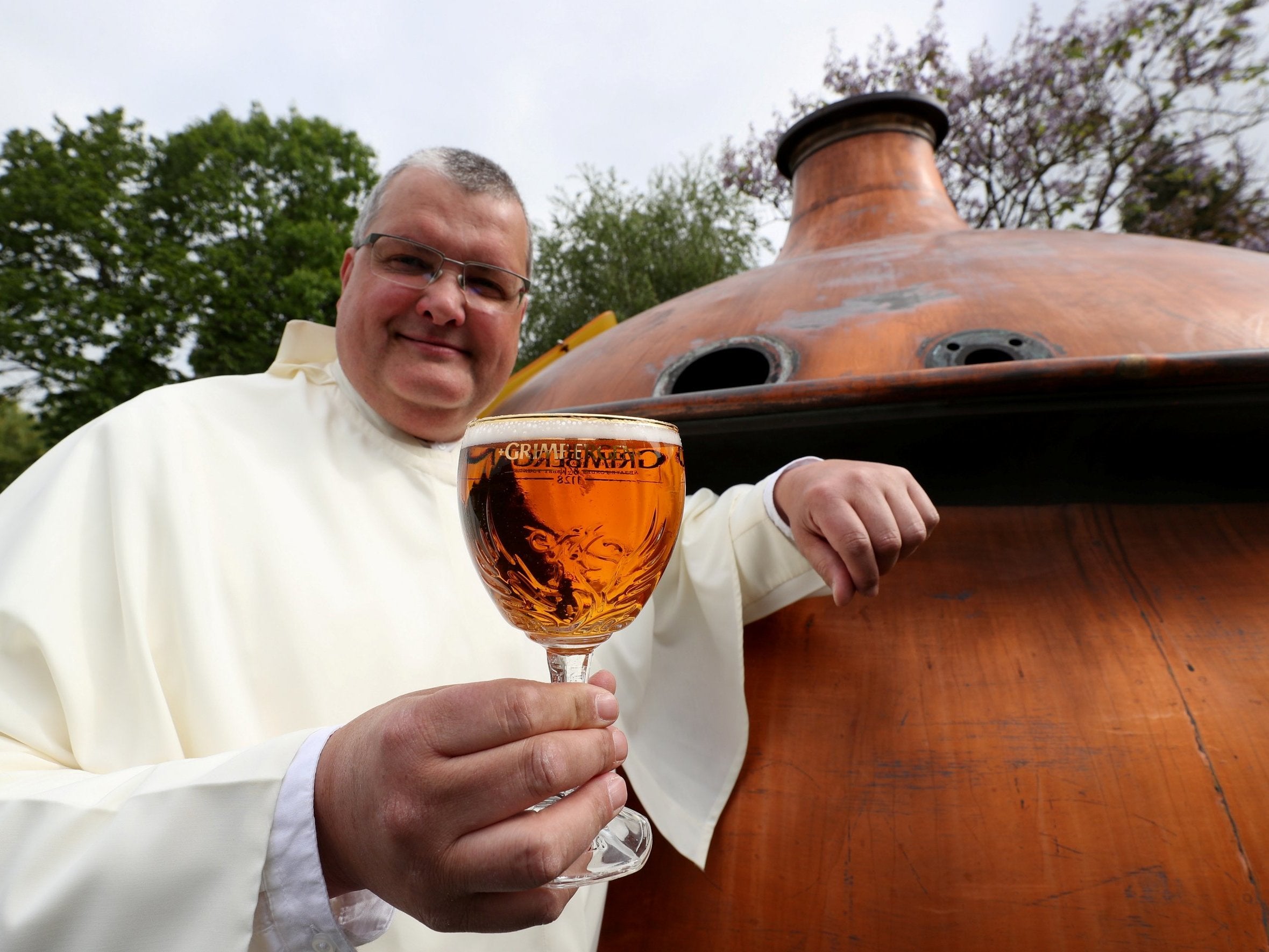 Norbertine Father Karel poses with a Grimbergen beer in the courtyard of the Grimbergen Abbey in Belgium.