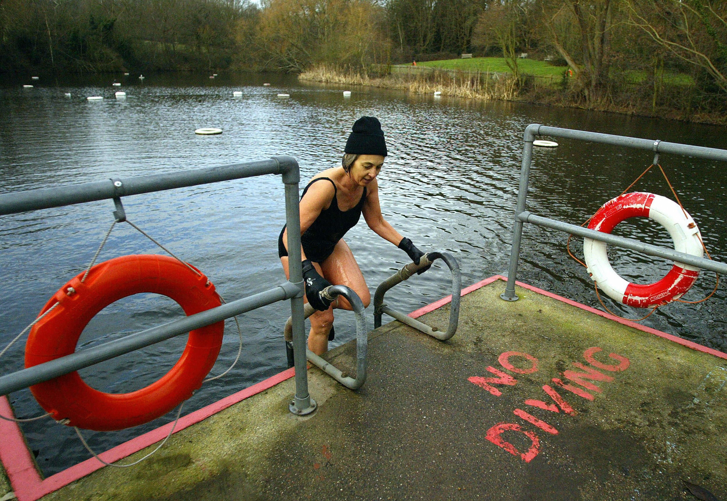 A woman takes a dip in the Hampstead Heath women's ponds in January 2005
