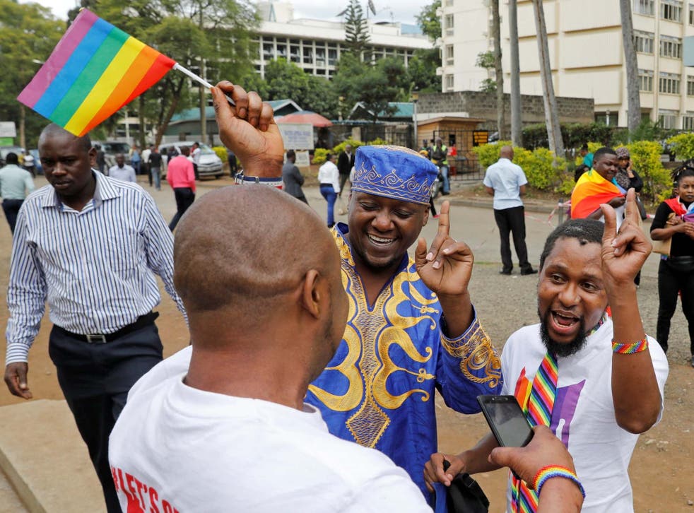 LGBT+ activists gather for the ruling on whether to uphold or nullify a law banning gay sex outside the Milimani high Court in Nairobi, Kenya