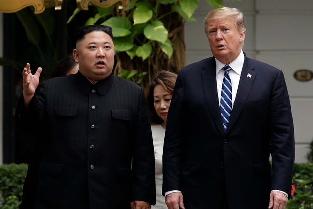 Donald Trump and Kim Jong-un take a walk after their first meeting at a Hanoi hotel