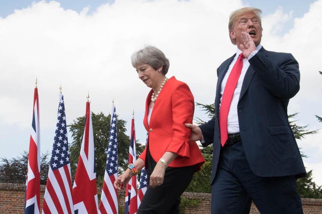 Donald Trump walking with Theresa May prior to a joint press conference at Chequers in July 2017