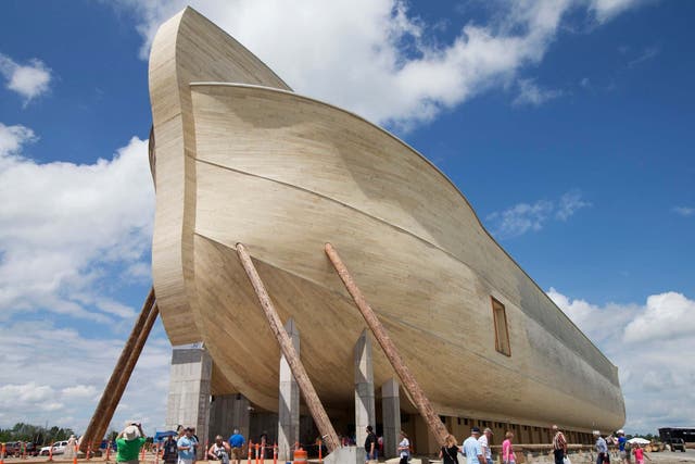 Visitors pass outside the front of a replica Noah's Ark at the Ark Encounter theme park during a media preview day