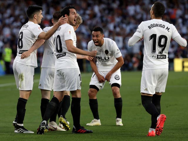 Valencia's players celebrate after the final whistle
