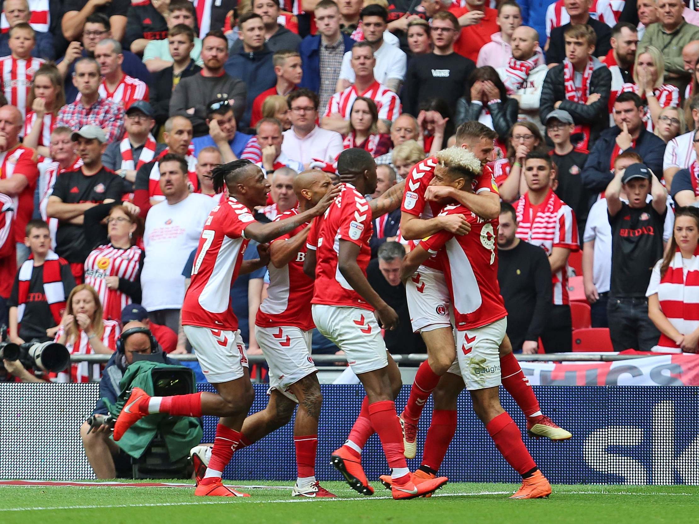 Charlton players swarm Ben Purrington after his equaliser