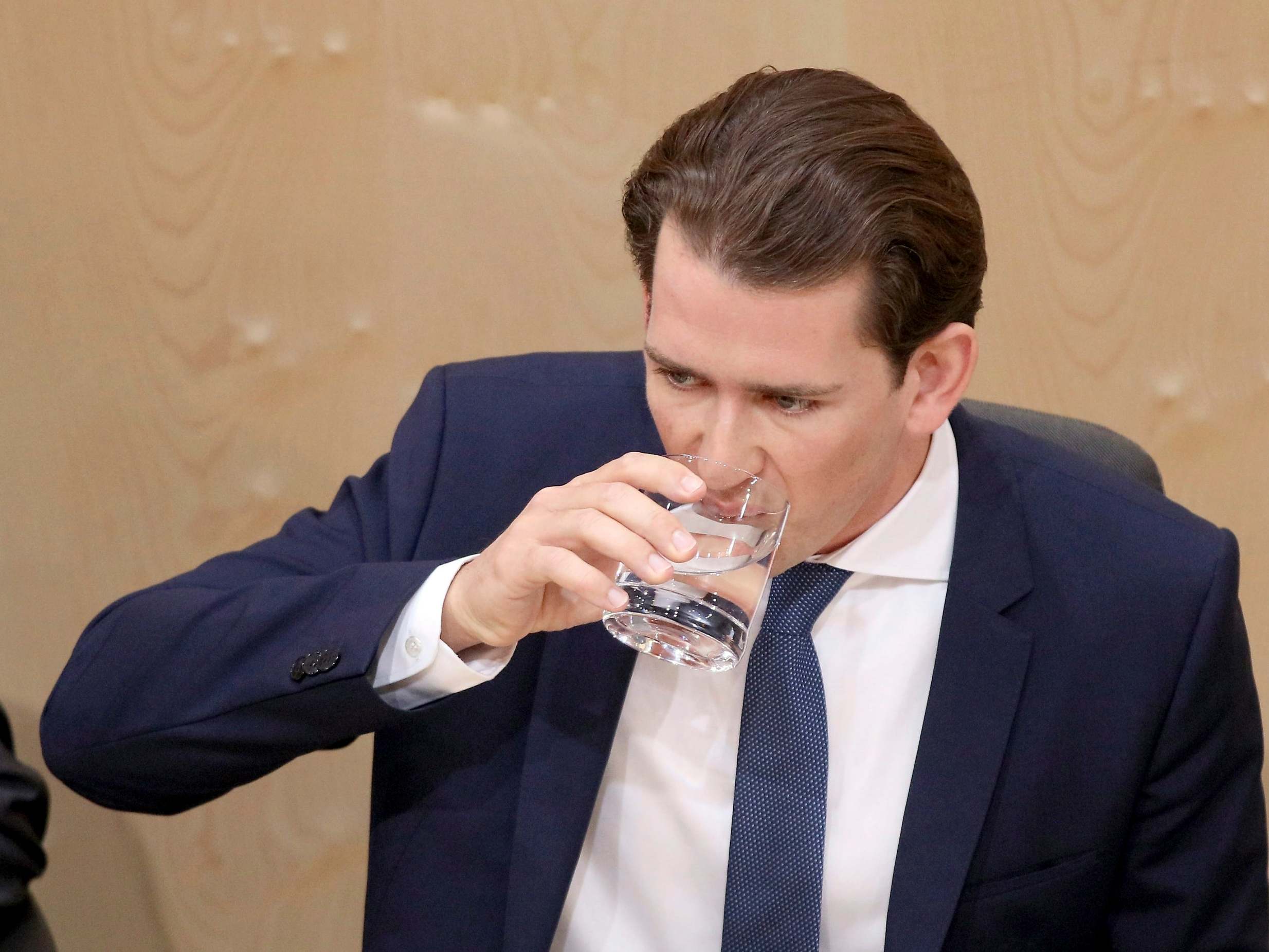 Austrian chancellor Sebastian Kurz takes a sip of water at the parliament in Vienna on Monday
