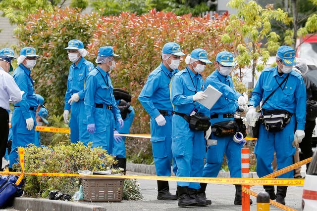 Police investigate the scene of a mass stabbing at a bus stop in Kawasaki, near Tokyo, Japan, 28 May 2019.