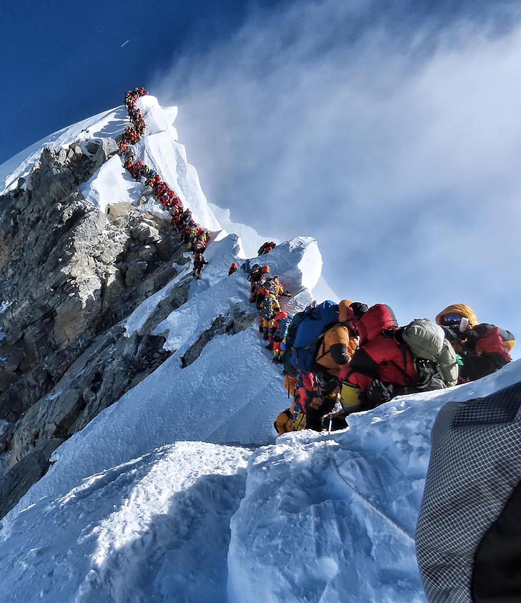 <p>A Project Possible image shows heavy traffic of mountaineers lining up to stand on top of Mount Everest</p>