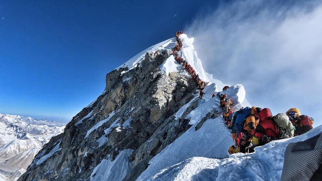 Climbers wait in line to reach the peak of Mount Everest