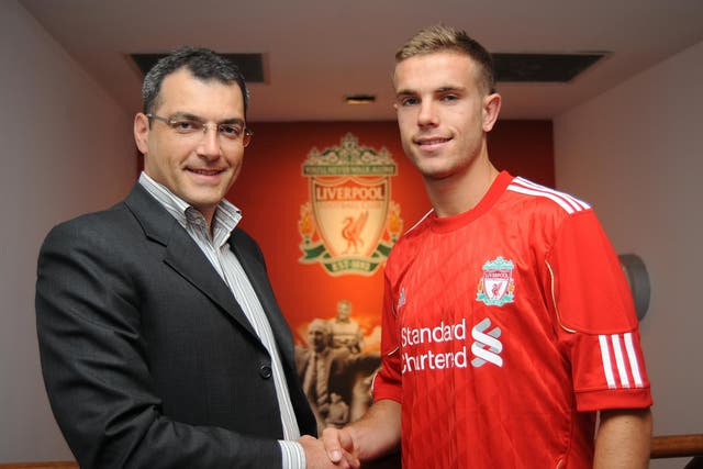 Director of Football for Liverpool Damien Comolli stands by Jordan Henderson