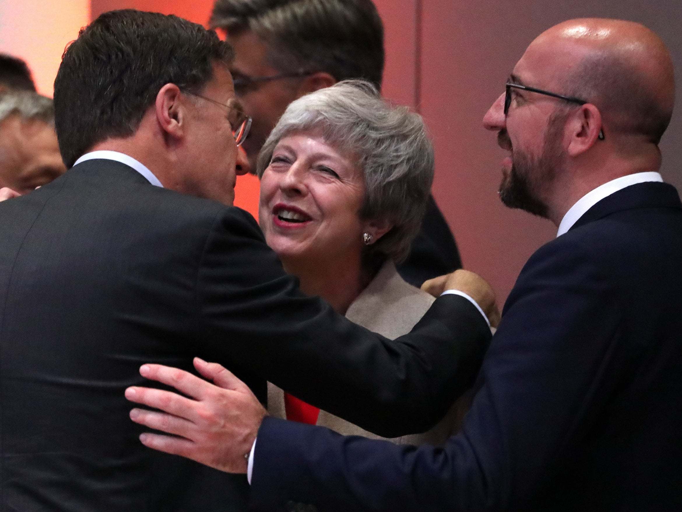Dutch Prime Minister Mark Rutte and Belgian prime minister Charles Michel greet Theresa May at the European Council summit
