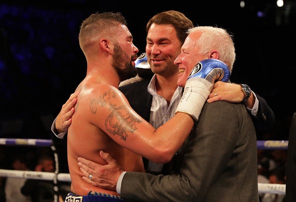 Eddie Hearn celebrates with his father and Tony Bellew