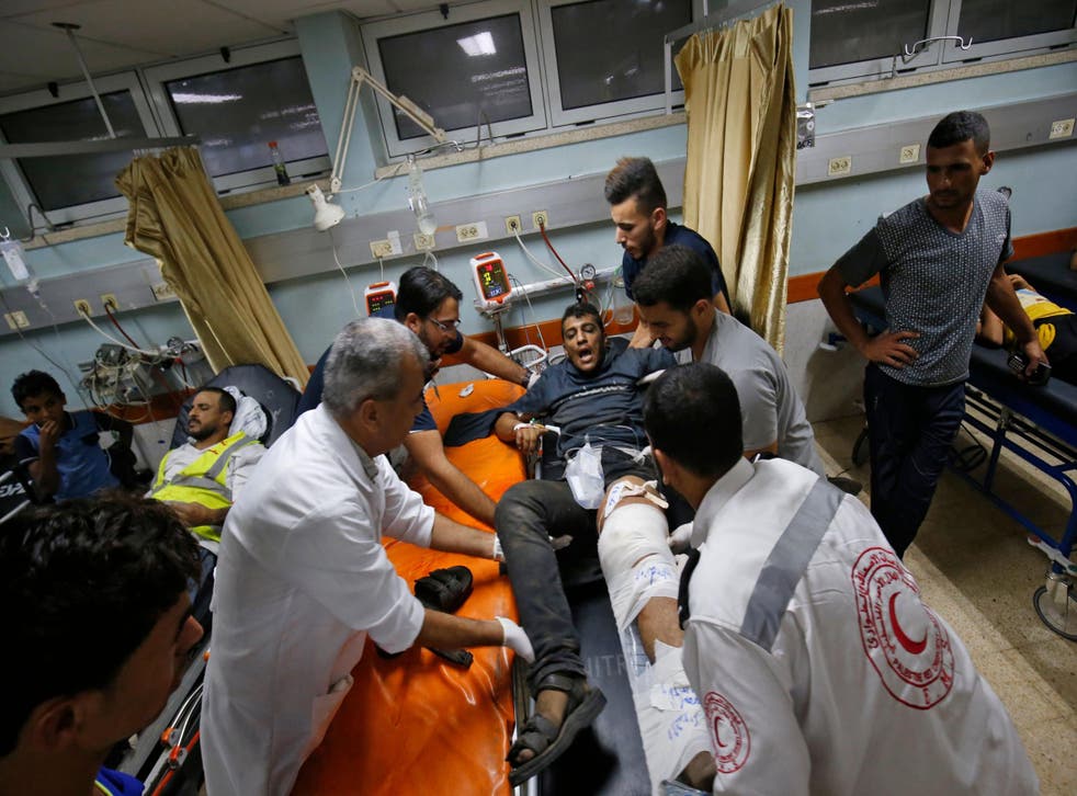 Palestinian paramedics tend to a youth who was injured during clashes by the border with Israel, at a hospital in Khan Yunis in the southern Gaza Strip 