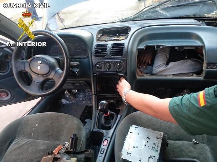 A man was discovered squeezed into a glove box behind a car's dashboard by border guards as he attempted to cross from Morocco into the Spanish enclave of Melilla, on the north African coast.