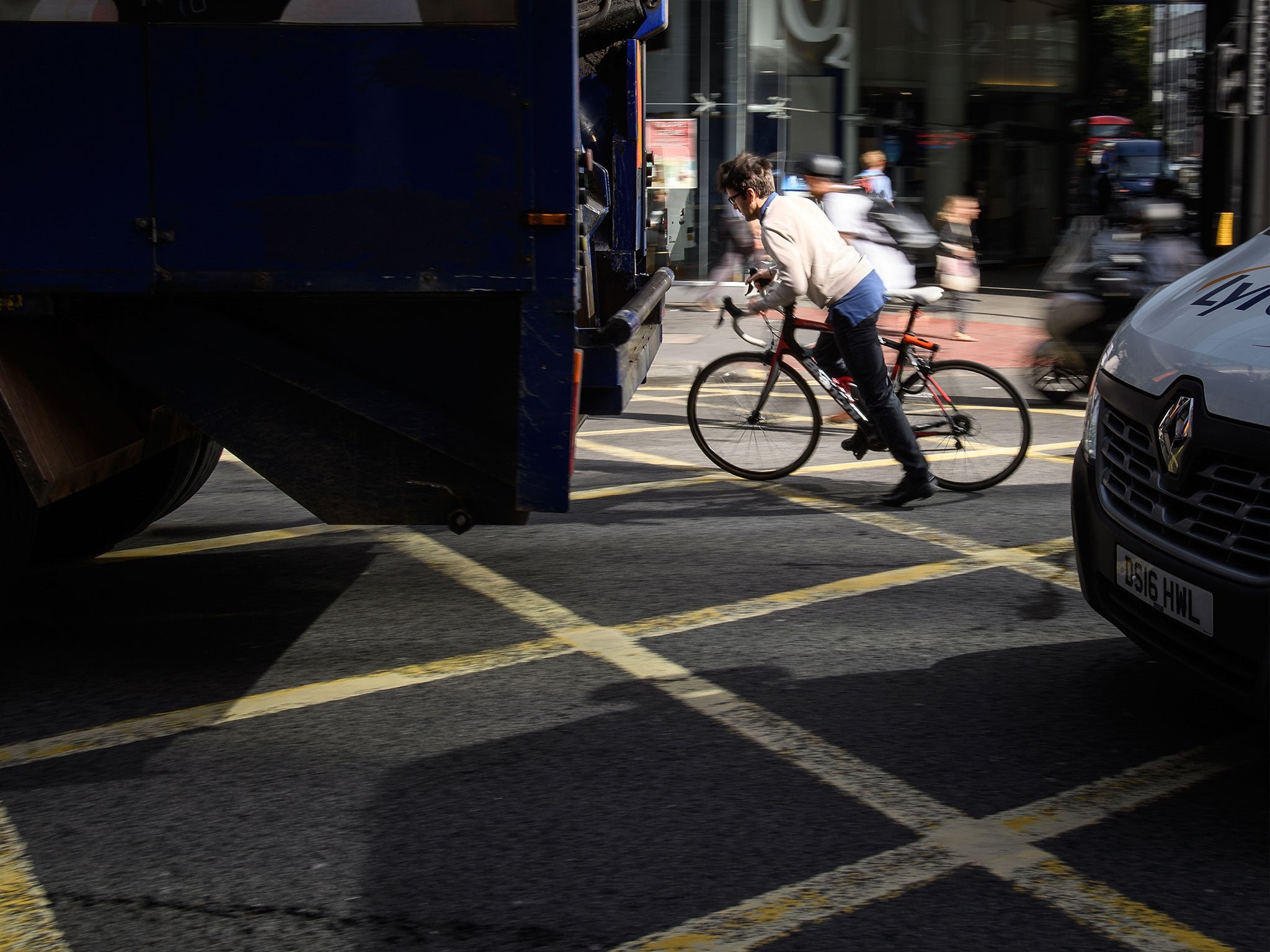 A cyclist negotiates the busy streets of the capital