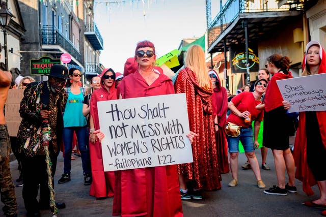 Handmaid-themed protesters march in the French Quarter of New Orleans, Louisiana, to protest the proposed "heartbeat bill" that bans abortion after six weeks in that state.