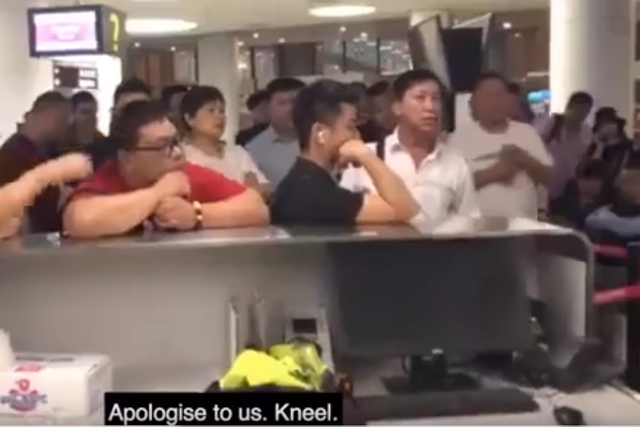 An angry passenger demanded that an airline worker kneel to apologise for a flight delay