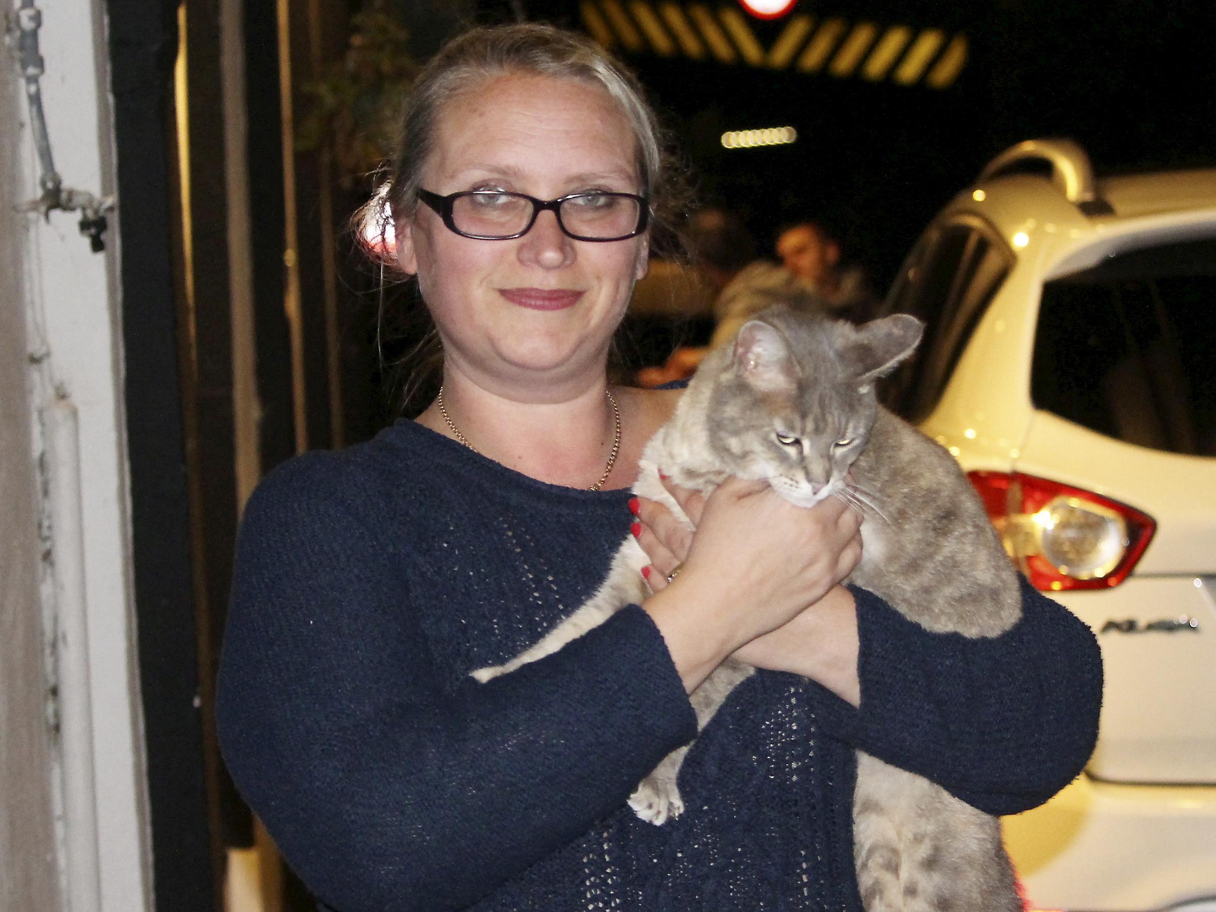 Kirsty Howden, 39, of Saltash, Cornwall, is reunited with her pet cat Hatty, who was stuck up a bridge for six days.