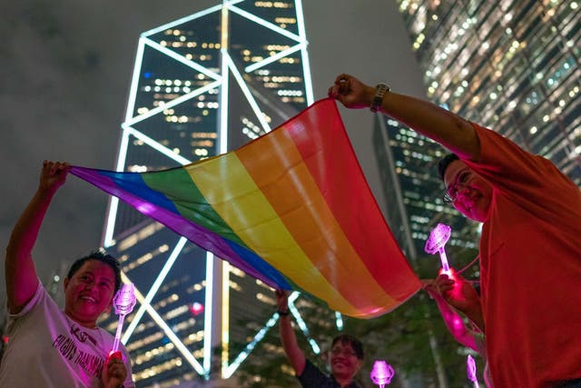 LGBT+ supporters hold a rainbow flag as they take part in a gathering for the 2019 International Day Against Homophobia in Hong Kong