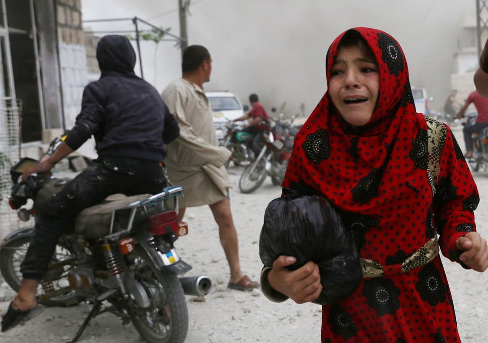A Syrian girl runs for cover during an airstrike in Kfar Ruma last week