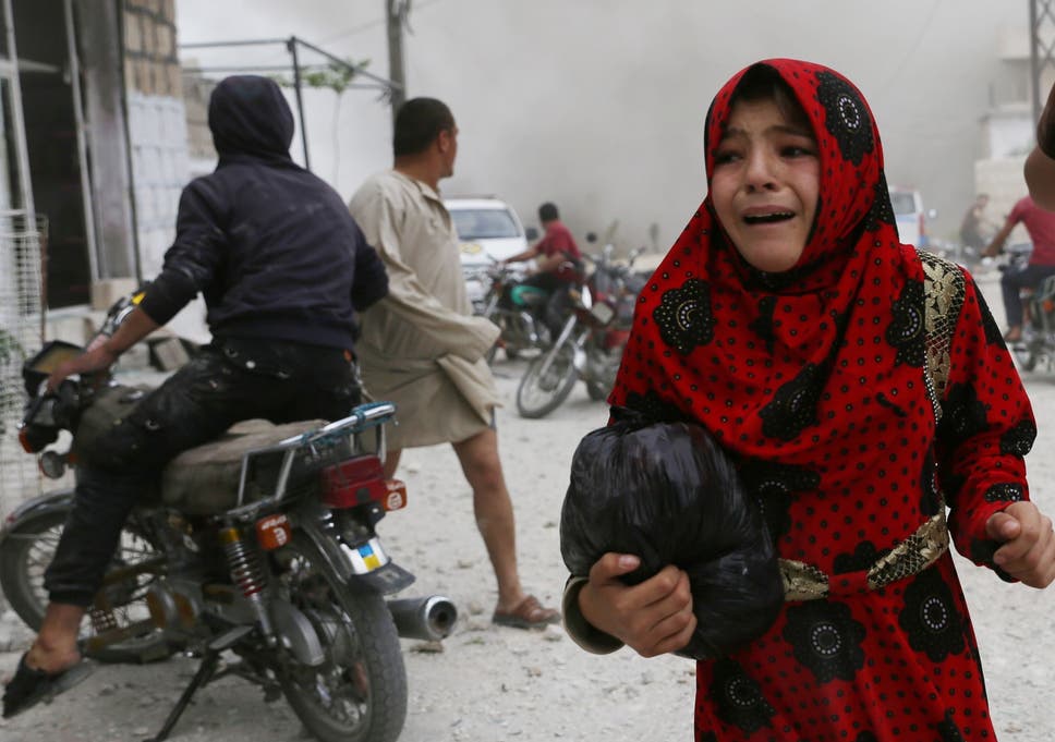 A Syrian girl runs for cover during an airstrike by pro-regime forces on Kfar Ruma last week