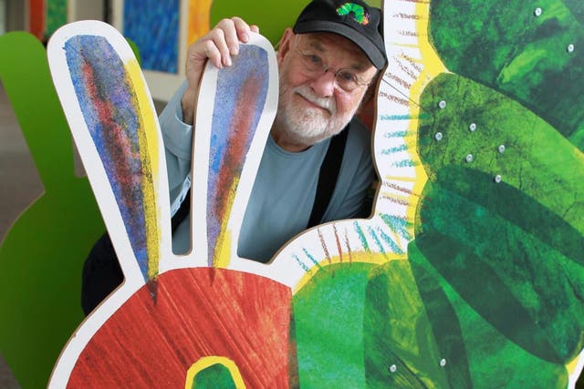 Eric Carle stands with a large cutout of the iconic image from his children’s book at the Eric Carle Museum of Picture Book Art in Amherst, Massachusetts