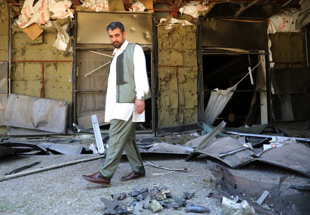 A man walks in front of Rixos hotel damaged by a rocket in Tripoli, Libya, 24 May