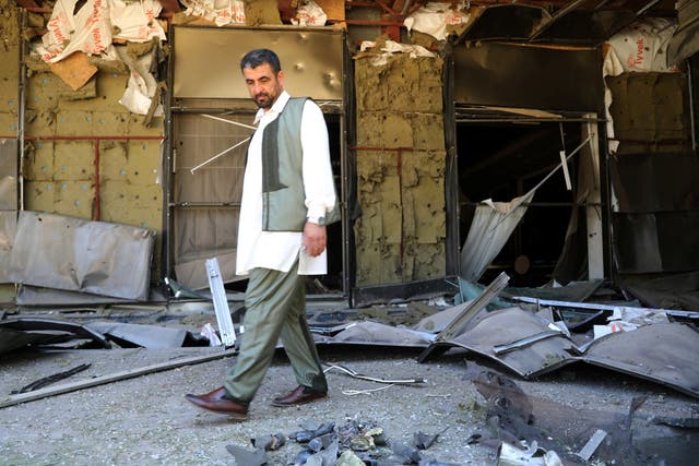 A man walks in front of Rixos hotel damaged by a rocket in Tripoli, Libya, 24 May