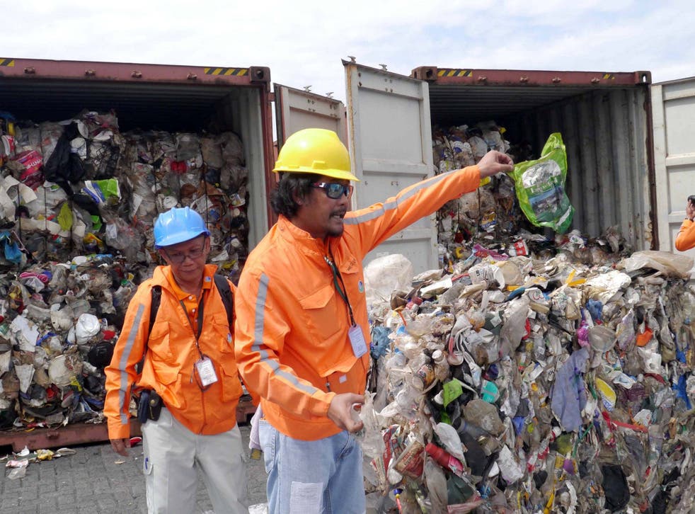 Philippine customs officials inspect cargo containers containing tonnes of rubbish shipped by Canada at Manila port