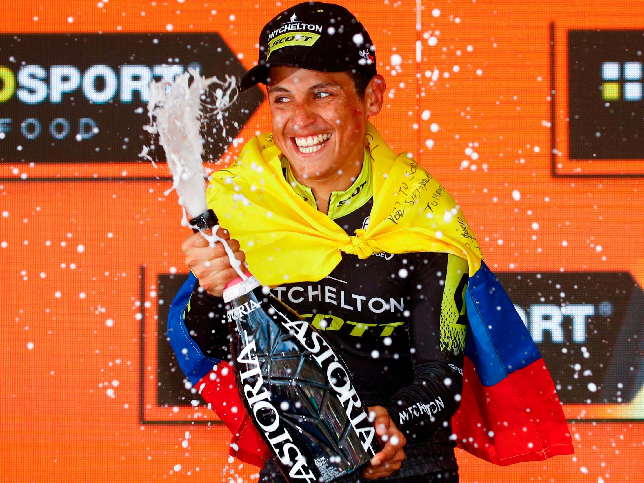 Esteban Chaves sprays champagne as he celebrates on the podium