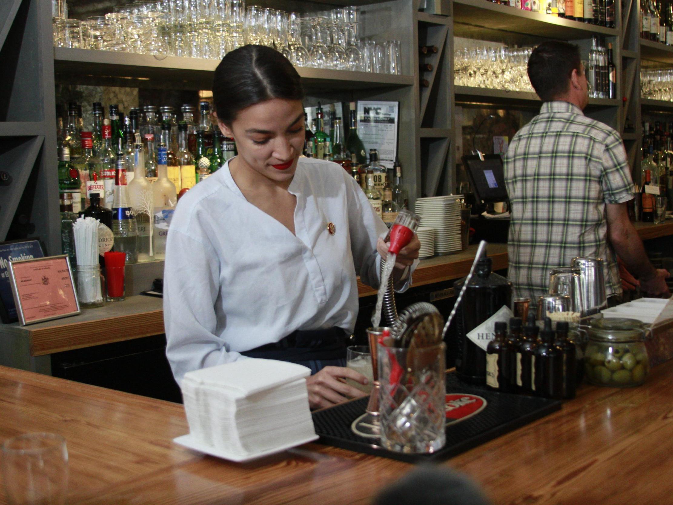 Rep. Alexandria Ocasio-Cortez mixes margaritas while tending bar at a restaurant in the Queens borough of New York on Friday 31 May 2019.