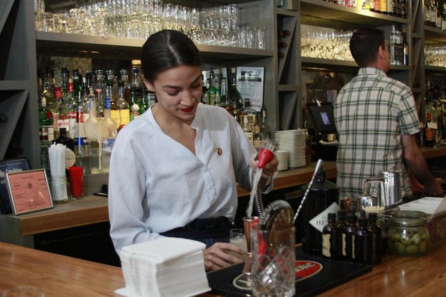Rep. Alexandria Ocasio-Cortez mixes margaritas while tending bar at a restaurant in the Queens borough of New York on Friday 31 May 2019.