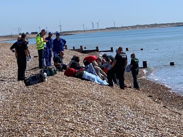 Eight men on Winchelsea Beach after apparently crossing the Channel