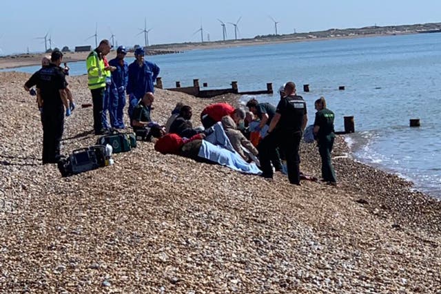 Eight men on Winchelsea Beach after apparently crossing the Channel