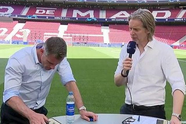 Jamie Carragher is caught on his phone during a live broadcast