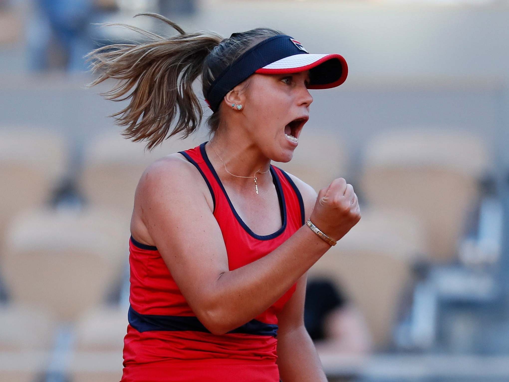 Alize Cornet of France celebrates beating Serena Williams of the