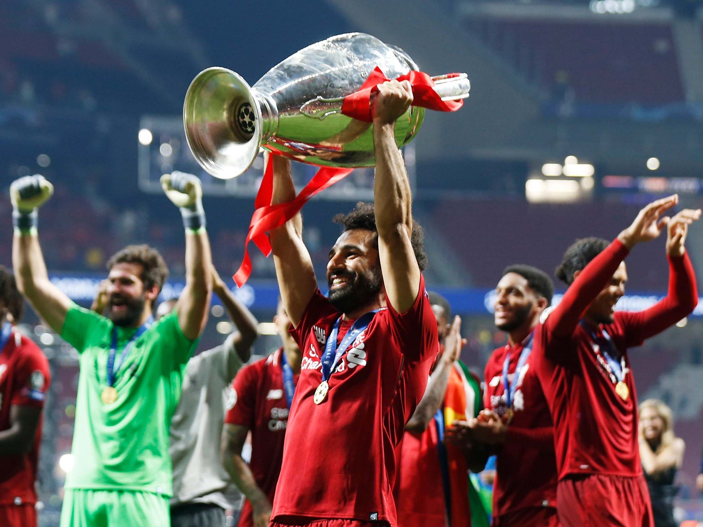 Mohamed Salah celebrates with the trophy