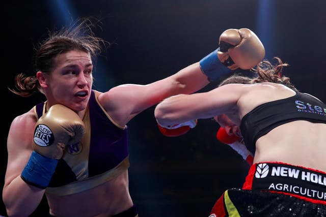 Katie Taylor throws a left at Delfine Persoon in their lightweight unification bout