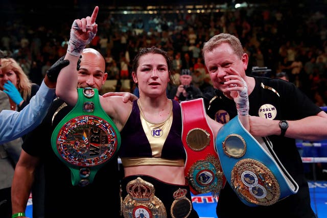 Katie Taylor celebrates becoming the undisputed lightweight champion by beating Delfine Persoon