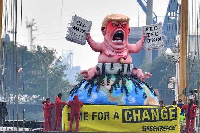 Greenpeace activists depicted the US president in Germany in 2017 tearing up a climate-protection agreement