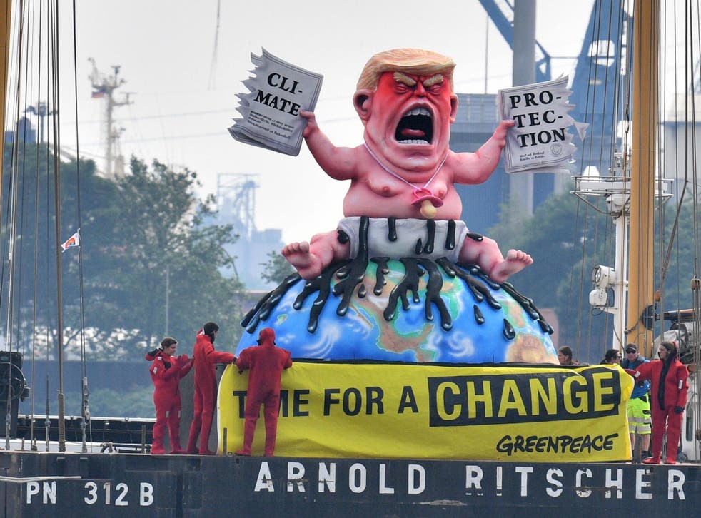 Greenpeace activists depicted the US president in Germany in 2017 tearing up a climate-protection agreement