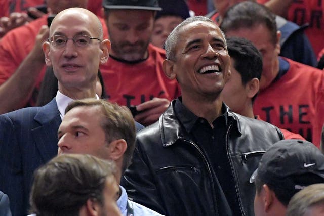 Barack Obama (right) and NBA commissioner Adam Silver (right) watch the NBA finals