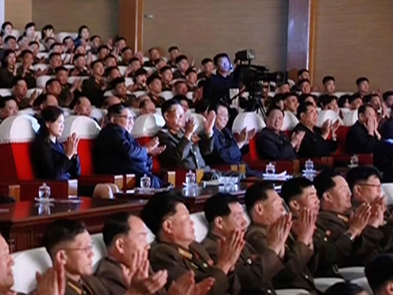 Kim Yong-chol can be seen sitting on the far right, with his hands partially covering his face