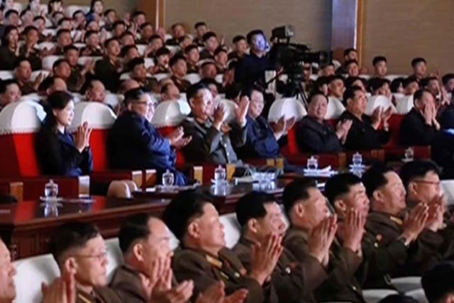 Kim Yong-chol can be seen sitting on the far right, with his hands partially covering his face