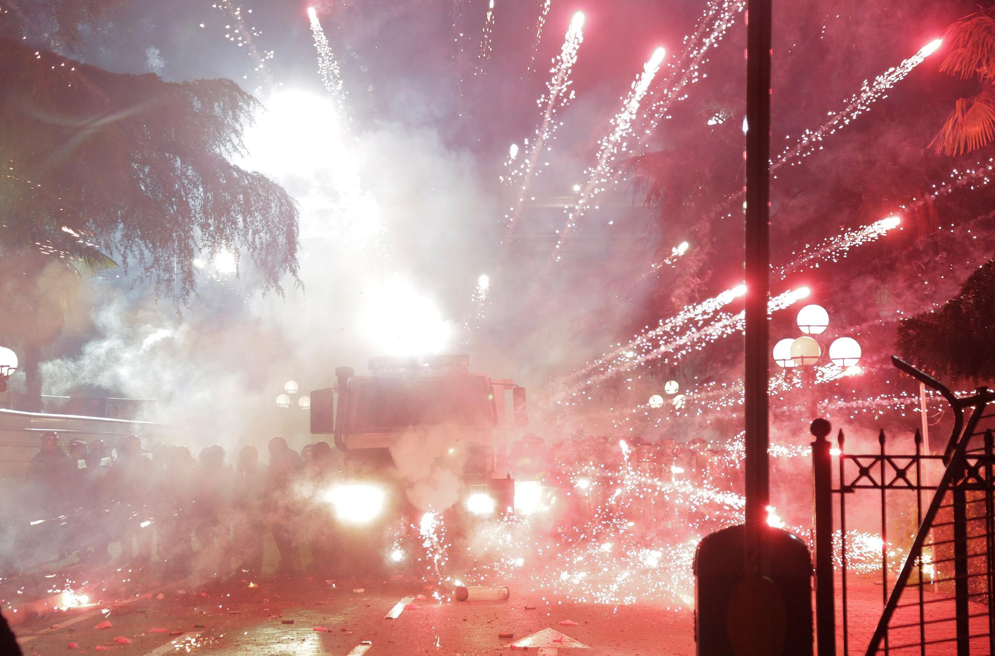 As opposition party leader Lulzim Basha gave a speech to protesters outside the parliament in Tirana, some of those in the crowd began to hurl firecrackers, smoke bombs and flares at the government building.