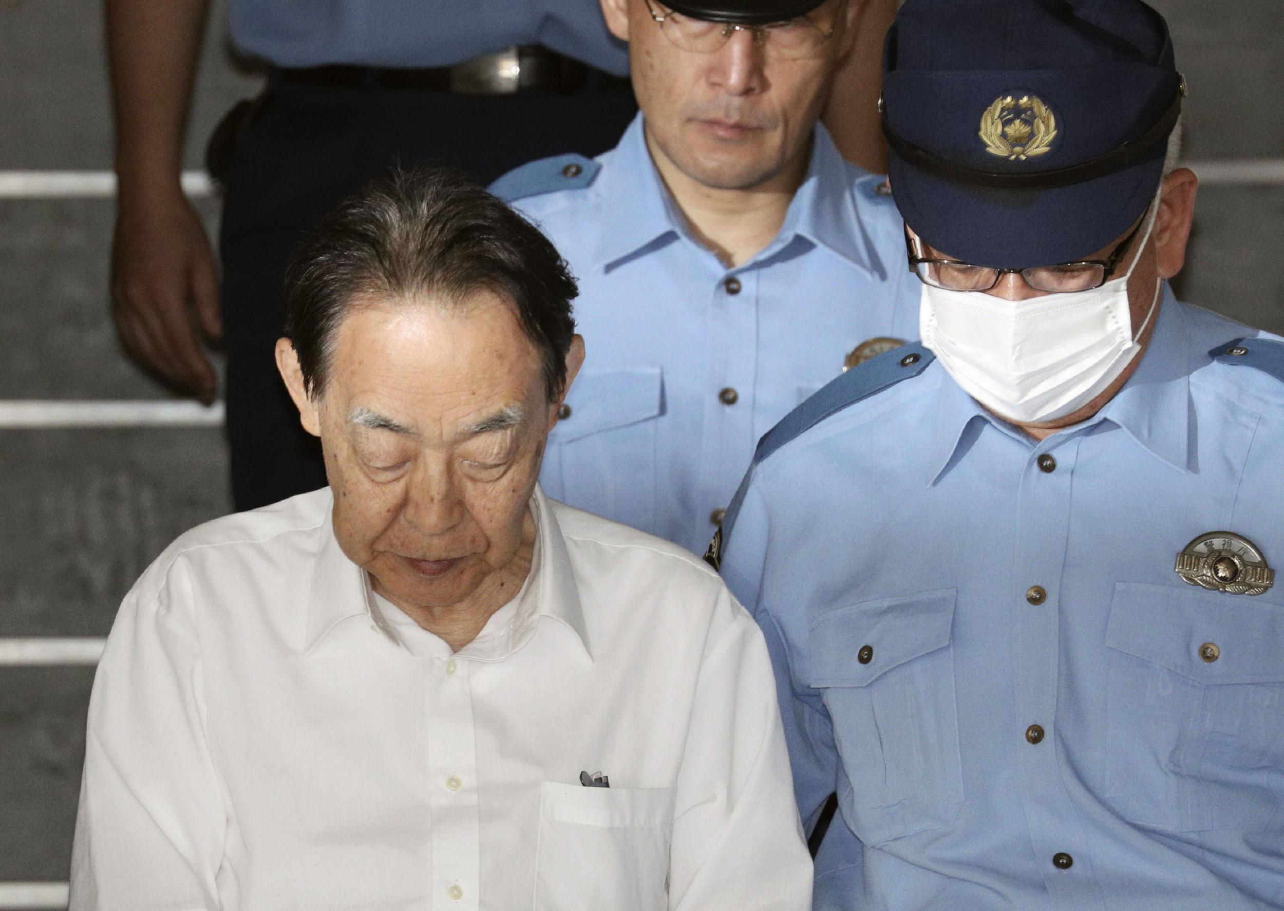 Hideaki Kumazawa leaving police station after he reportedly told investigators he feared his late son might harm others